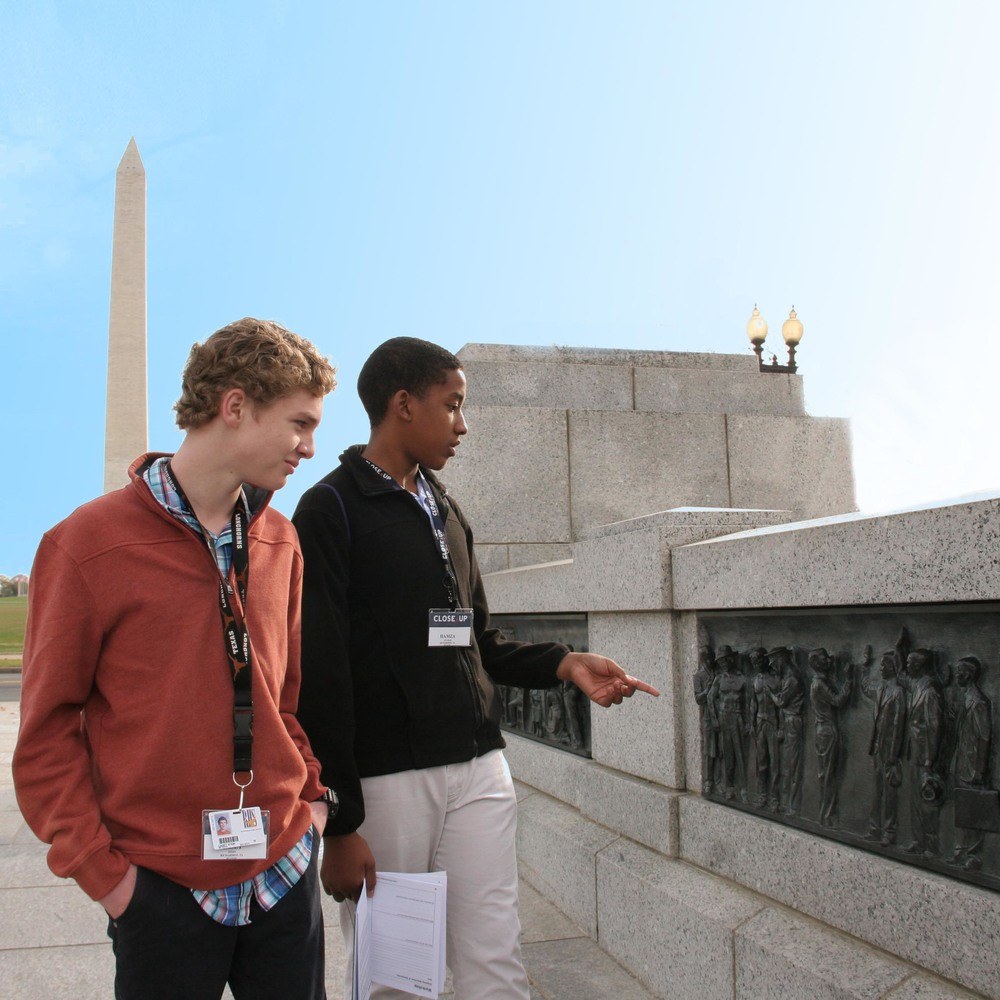Two male high school students looking at World War II Memorial in Washington, DC